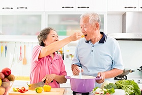 older couple cooking and eating healthy foods