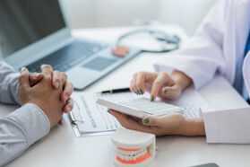 Patient learning the cost of cosmetic dentistry  