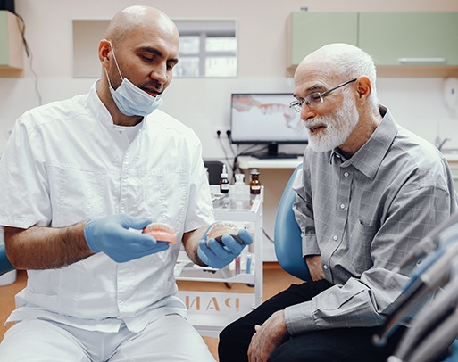 A handsome older man talking to his dentist