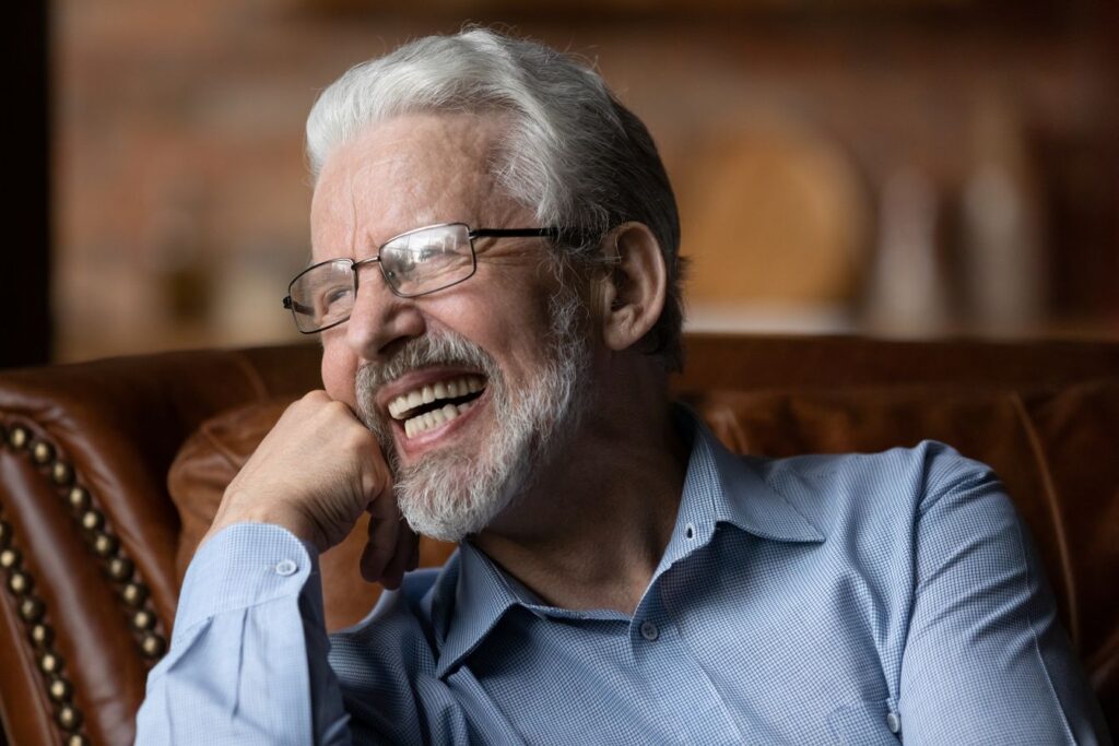 A man smiling in his new dentures